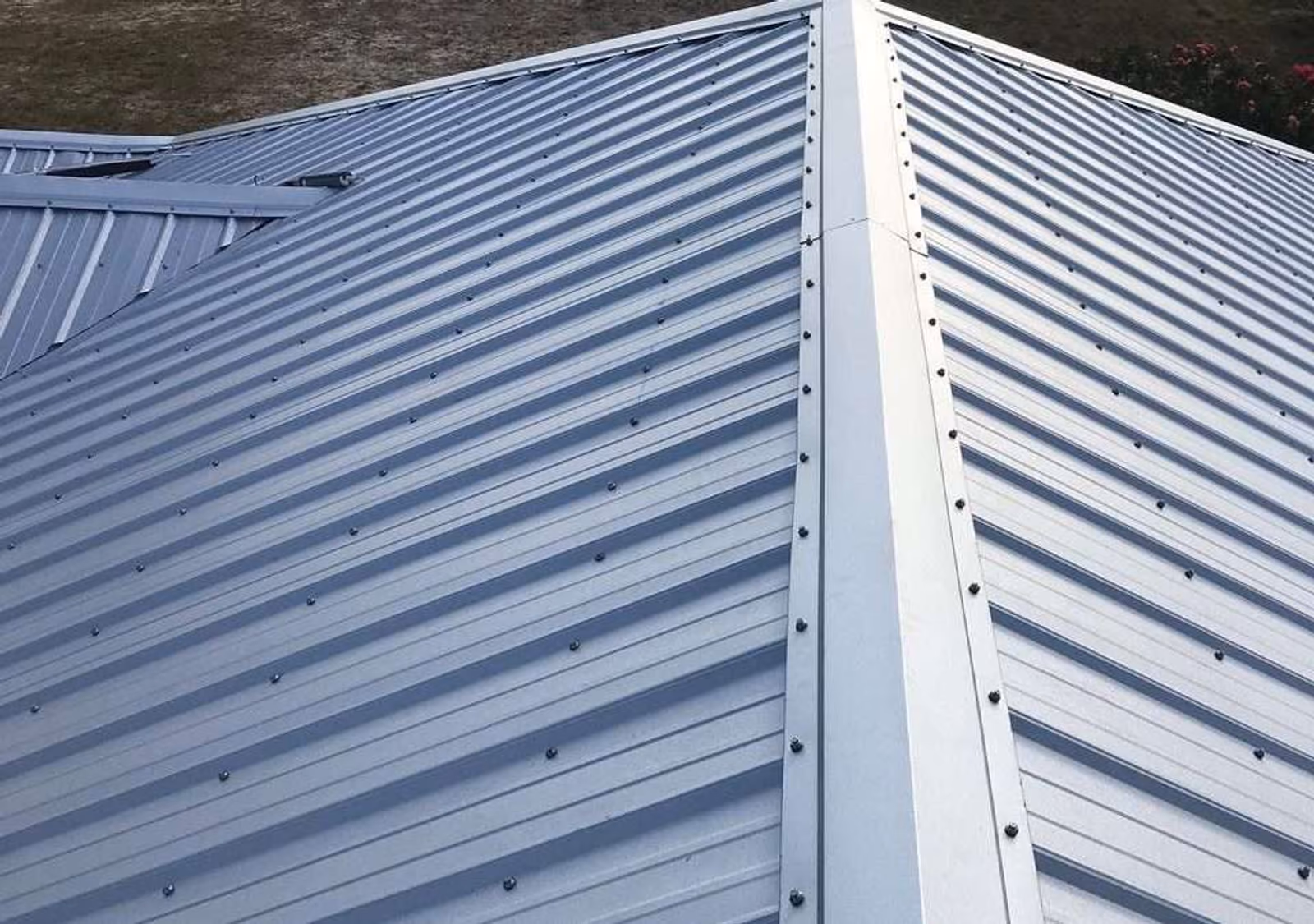 Ribbed metal roofing panels running along a home's roofline