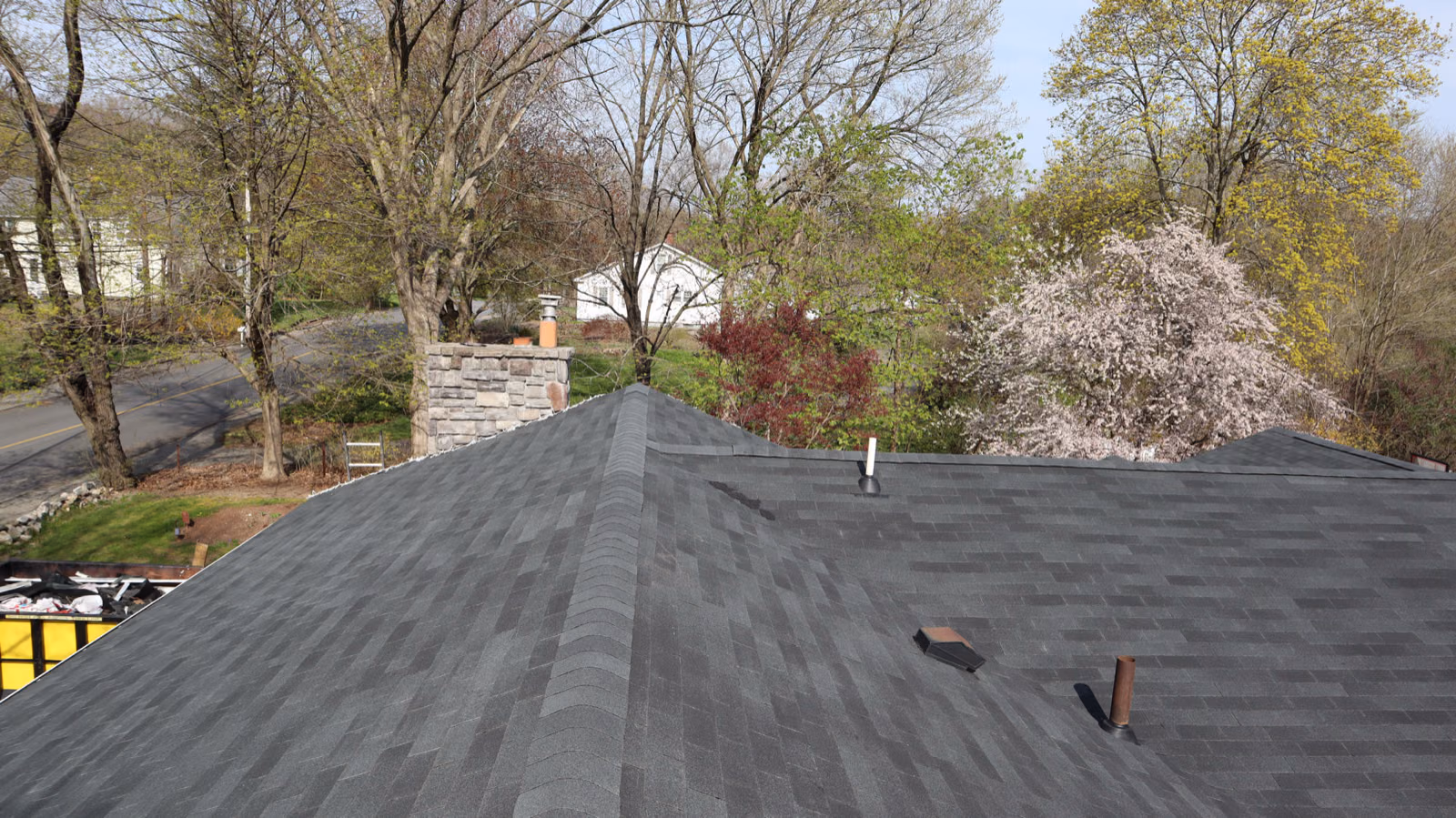 Completed roof next to stone chimney