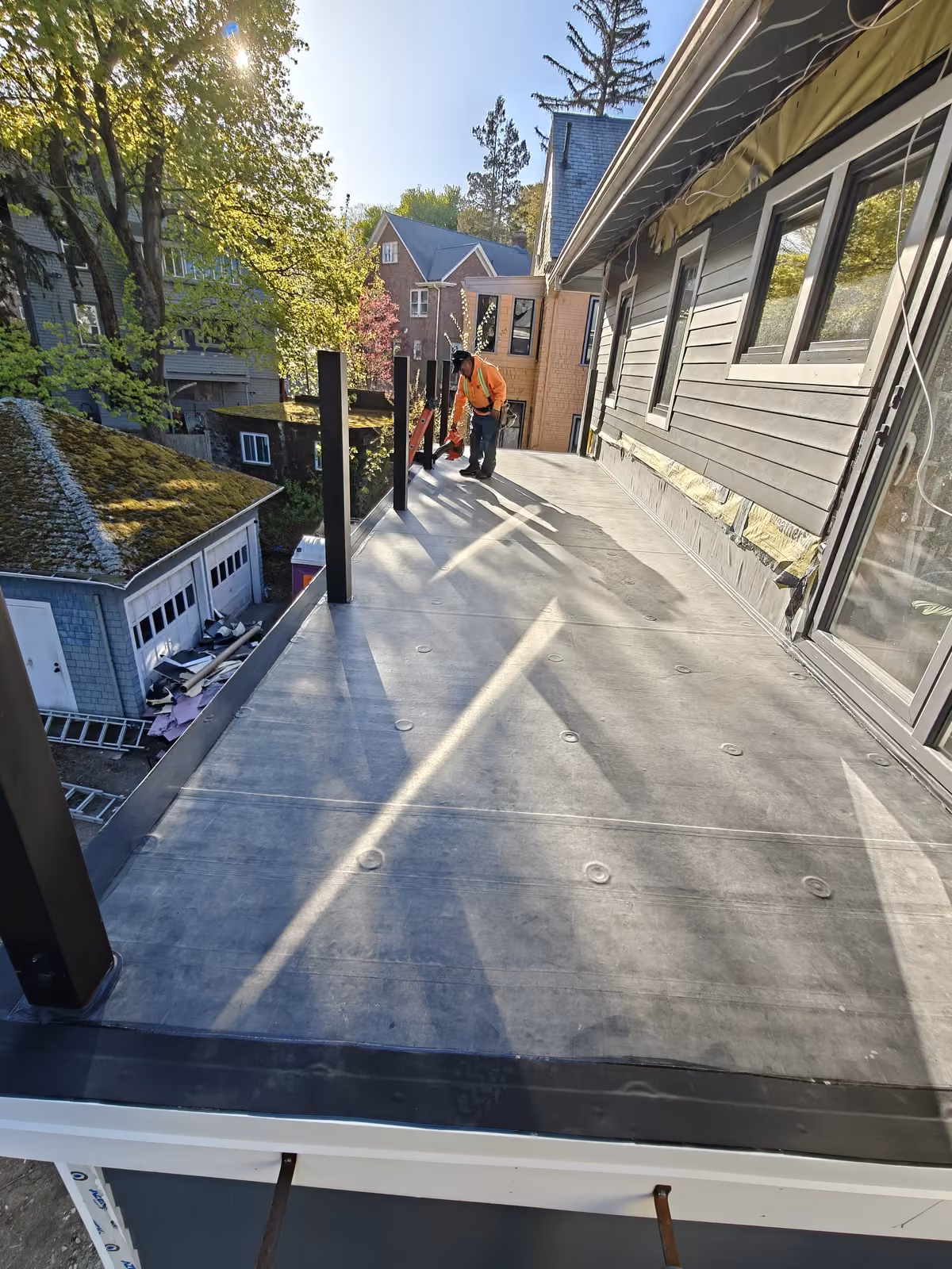 Flat membrane roof deck with crew finishing the install