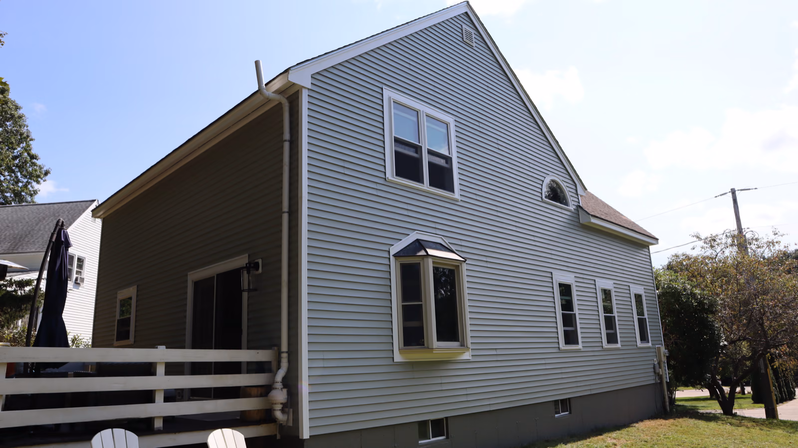 New sage lap siding with white trim